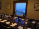 Picture of large window in private wine room, set up for a table of twelve.